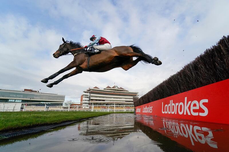 William H Bonney, ridden by Tom Bellamy, clears the water jump during the Ladbrokes Daily Odds Boosts Chase at Newbury Racecourse in England on Friday, November 27. PA