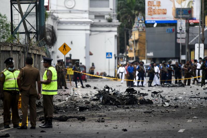 Sri Lankan security personnel inspect the debris of a car after it explodes when police tried to defuse a bomb near St. Anthony's Shrine in Colombo on April 22, 2019, a day after the series of bomb blasts targeting churches and luxury hotels in Sri Lanka. The death toll from bomb blasts that ripped through churches and luxury hotels in Sri Lanka rose dramatically April 22 to 290 -- including dozens of foreigners -- as police announced new arrests over the country's worst attacks for more than a decade.
 / AFP / Jewel SAMAD
