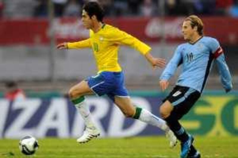 Brazil's Kaka, left, fights for the ball with Uruguay's Diego Forlan during a World Cup 2010 qualifying soccer match in Montevideo, Saturday, June 6, 2009. (AP Photo/Andres Cuenca) *** Local Caption ***  EDB110_Uruguay_Brazil_Wcup_Soccer.jpg
