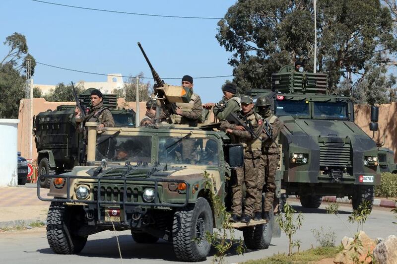 Tunisian soldiers patrol a street in Ben Guerdanem on March 13, a week after jihadists launched a wave of attacks on army and police posts in the border town. Fathi Nasri / AFP