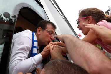 Opposition candidate Ekrem Imamoglu greets supporters from his campaign bus after a rally in Istanbul on June 21, 2019. AP Photo