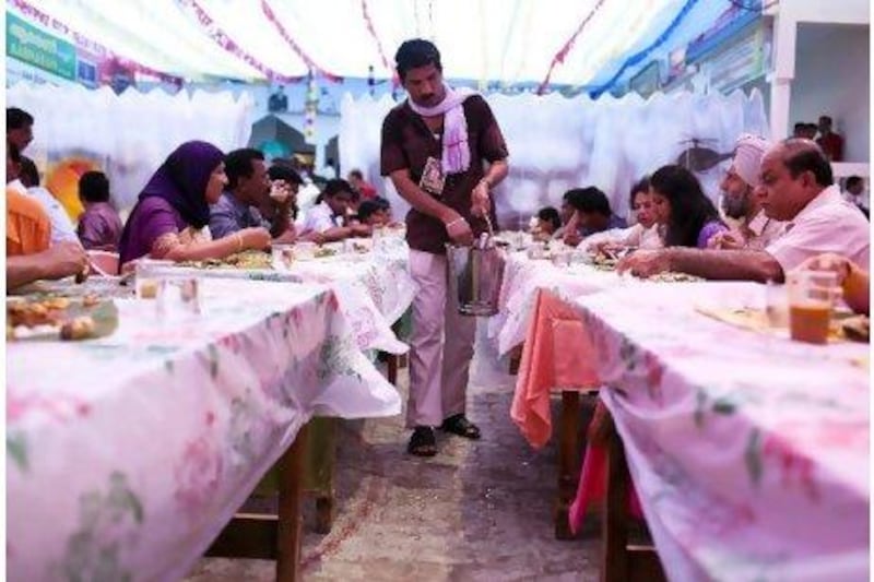 A volunteer serves food during Onam celebrations at the Kerala Social Centre in Abu Dhabi last year.