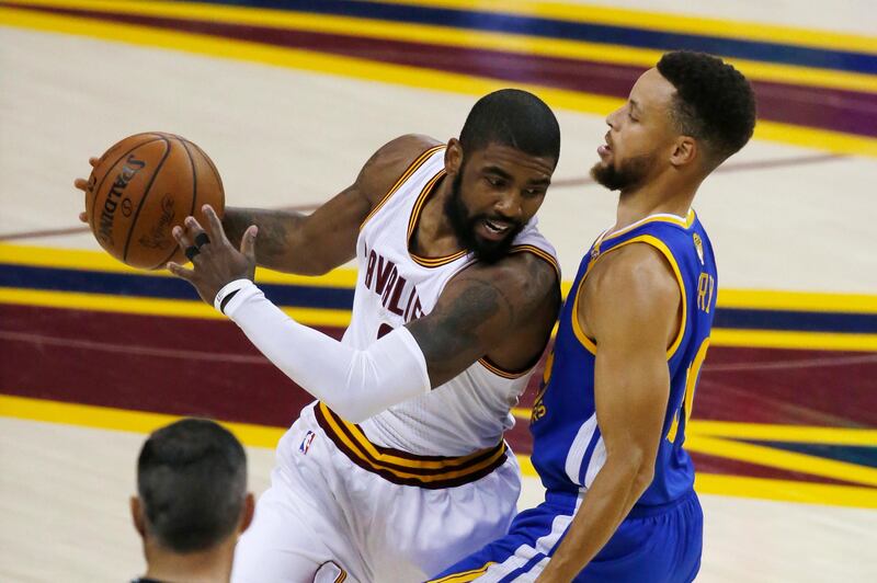 FILE - In this June 7, 2017, file photo, Cleveland Cavaliers guard Kyrie Irving (2) is guarded by Golden State Warriors guard Stephen Curry (30) during the first half of Game 3 of basketball's NBA Finals in Cleveland. Irving gets his new address and Isaiah Thomas gets to play with LeBron. They both can say they won in this Celtics-Cavs blockbuster deal. But the sum of the parts says Cleveland got the better of Boston in this swap of All-Star point guards. (AP Photo/Ron Schwane, File)