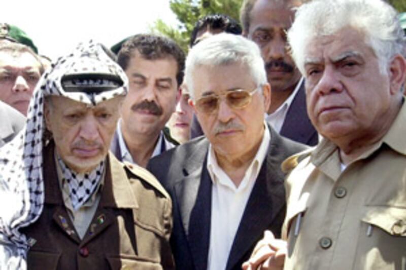 Sakher Habash, right, with Mahmoud Abbas, centre, and Yasser Arafat, left, at the funeral of Abbas' son Mazen in Ramallah in 2002.