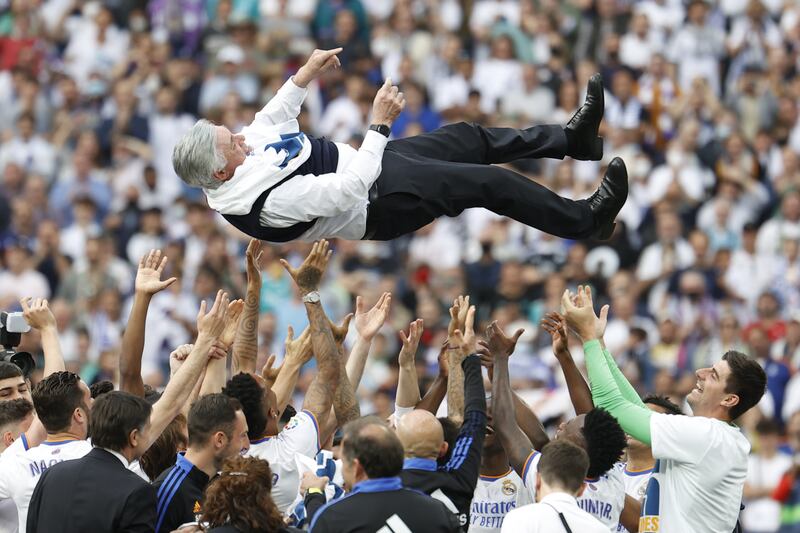 Real Madrid players throw coach Carlo Ancelotti into the air. EPA