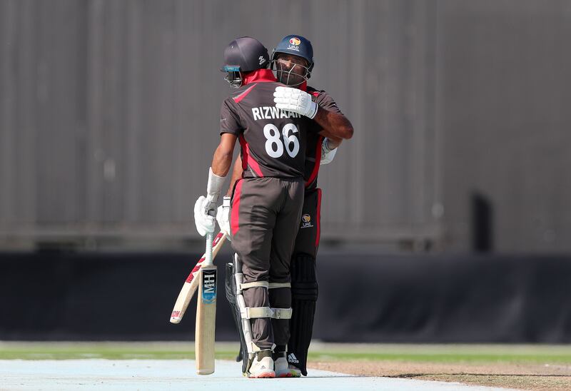The UAE's Asif Khan with his batting partner CP Rizwan after reaching fifty. 