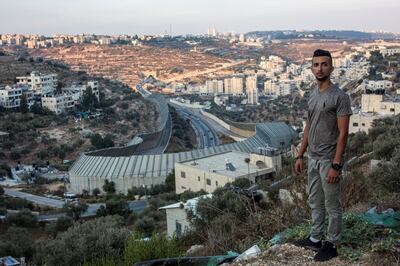 Taysir Saify, 20, stands on a hill in the Palestinian city of Beit Jala that overlooks Jerusalem in the early evening . Below the hilly landscape , is a portion of Israel's concrete separation barrier wall that hugs over the area of the main road Route 60 that connects Jerusalem to the West Bank.  
Unable to vote, but still controlled by Israeli policies, are Palestinian residents of Jerusalem and Palestinians living in the occupied West Bank and Gaza Strip.
(Photo by Heidi Levine for The National).