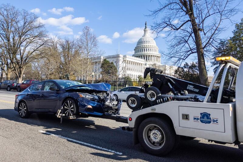 Officials remove the vehicle from the scene. EPA