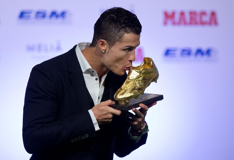 MADRID, SPAIN - NOVEMBER 05:  Cristiano Ronaldo of Real Madrid CF kisses his Golden Boot 2014 award at Melia Castilla hotel on November 5, 2014 in Madrid, Spain. Cristiano Ronaldo's 31 strikes in La Liga last season have given him his third Golden Boot award. This year he has shared the award with FC Barcelona player Luis Suarez for the best scorer in Europe. Both players have scored the same number of goals thorough 2013-2014 season.  (Photo by Gonzalo Arroyo Moreno/Getty Images)