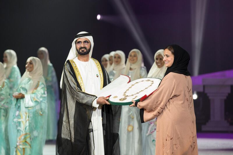 ABU DHABI, UNITED ARAB EMIRATES - March 21, 2016: HH Sheikh Mohamed bin Rashid Al Maktoum, Vice-President, Prime Minister of the UAE and Ruler of Dubai (center L) presents the Zayed Medal to HH Sheikha Lubna Al Qasimi, UAE Minister of State for Tolerance, (center R) who is receiving it on behalf of HH Sheikha Fatima bint Mubarak Al Nahyan (not shown), during the Mother of the Nation Festival opening ceremony at Abu Dhabi National Exhibition Centre (ADNEC).
( Ryan Carter / Crown Prince Court - Abu Dhabi ) *** Local Caption ***  20160321RC_C067893.jpg