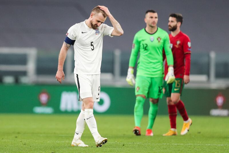 epa09095029 Azerbaijan's Maskim Medvedev, who scored an own-goal, reacts in the end of the FIFA World Cup Qatar 2022 Group A qualifier match Portugal against Azerbaijan in Turin, Italy, 24 March 2021.  EPA/MIGUEL A. LOPES