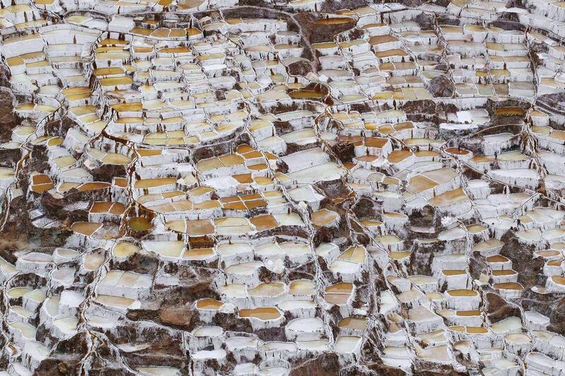 A view of salt ponds at the Maras mines in Cuzco. Salt has been obtained in Maras since pre-Incan times by evaporating highly salty local subterranean stream water. The water is intricately channelled through constructions, flowing gradually down on to several hundred ancient terraced ponds. From each pond, a local member of the mine cooperative can produce 150  to 200 kilos per month which can be sold in the markets at $0.34 per kilogram, according to miners. Enrique Castro-Mendivil / Reuters