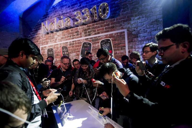 Visitors take a look at the new Nokia 3310 during its presentation on the eve of the opening of Mobile World Congress. Quique Garcia / EPA
