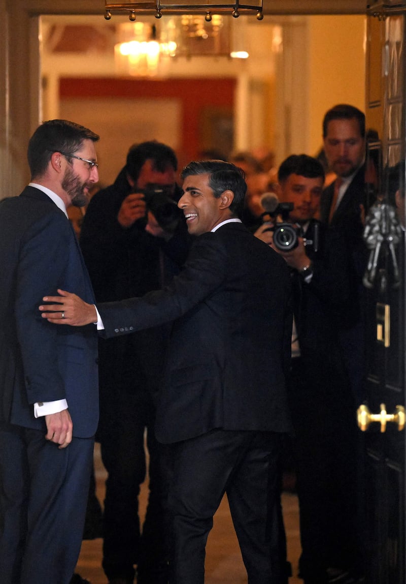 Mr Sunak is greeted by Cabinet Secretary and Head of the Civil Service Simon Case as he enters 10 Downing Street. AFP