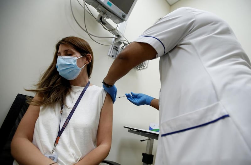 A woman receives a dose of the Pfizer-BioNTech vaccine at Zabeel Health Centre in Dubai. EPA