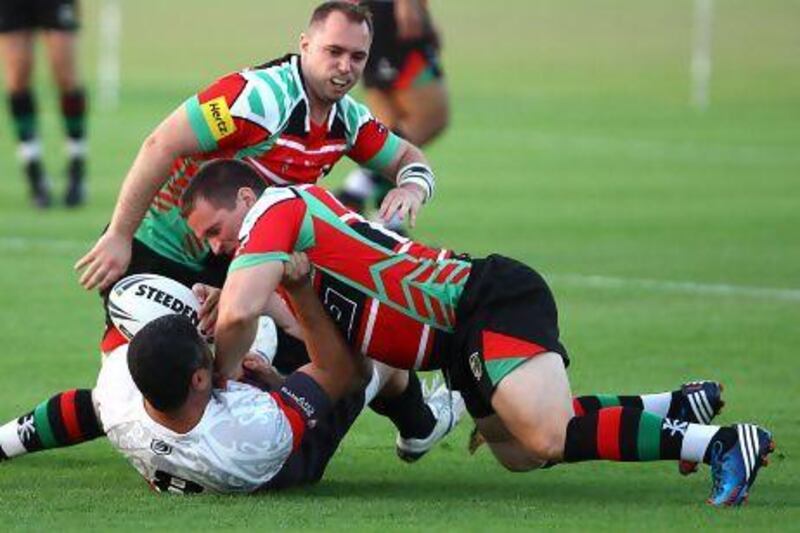 Abu Dhabi Harlequins, in red and green, had the Mana Dubai side covered, winning the Rugby League cup 62-10 yesterday.