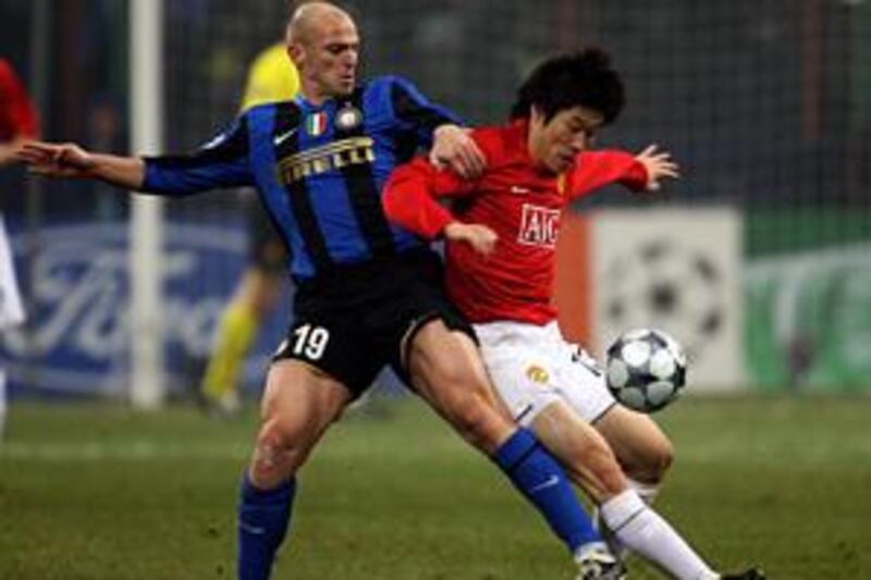 The Inter Milan midfielder Esteban Cambiasso battles with Ji-Sung Park of Manchester United in the 0-0 draw at the San Siro.