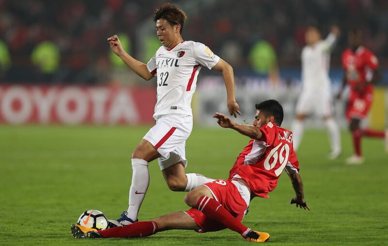 Persepolis player Ali Moslem Taklimi tackles Koki Anzai of the Kashima Antlers. Getty Images