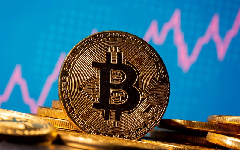 FILE PHOTO: A representation of virtual currency Bitcoin is seen in front of a stock graph in this illustration taken November 19, 2020. REUTERS/Dado Ruvic/Illustration/File Photo