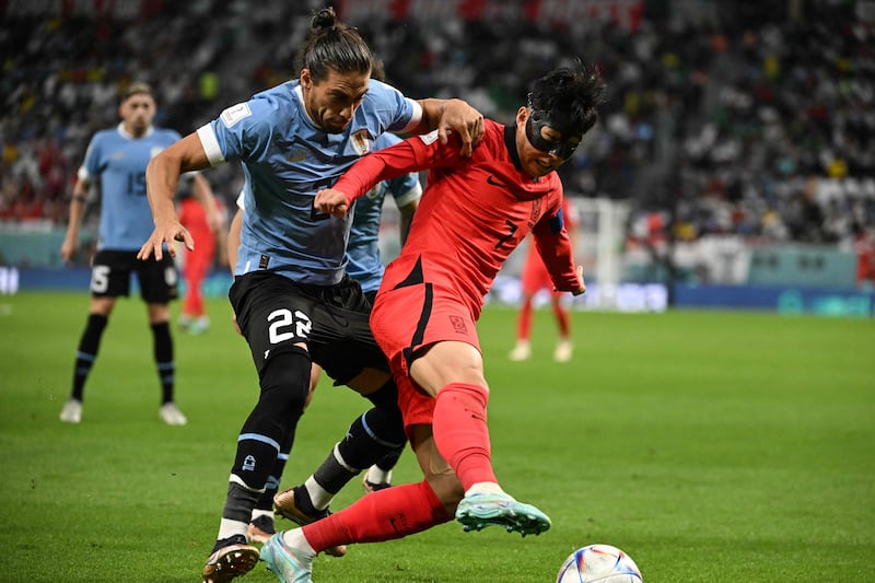 Uruguay's defender Martin Caceres fights for the ball with South Korea's midfielder Son Heung-min. AFP