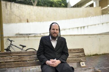 Akiva Weisfeld, 39, an ultra-Orthodox lawyer, sits outside his home in Jerusalem. Rosie Scammell for The National