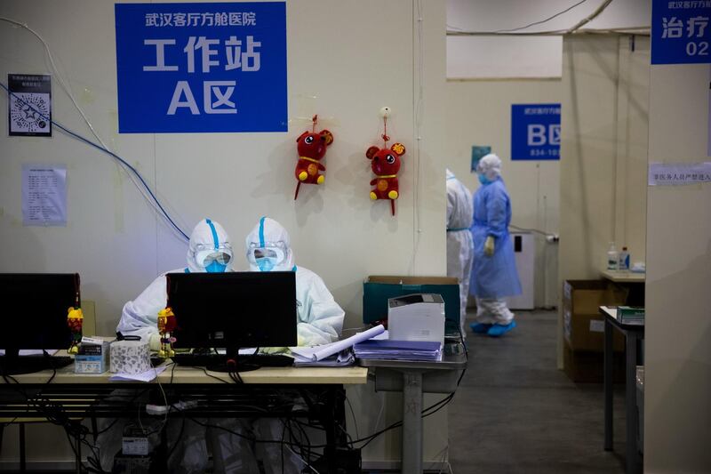 Medical staff in protective suits work at Wuhan Fang Cang makeshift hospital in Wuhan, Hubei Province, China.  EPA