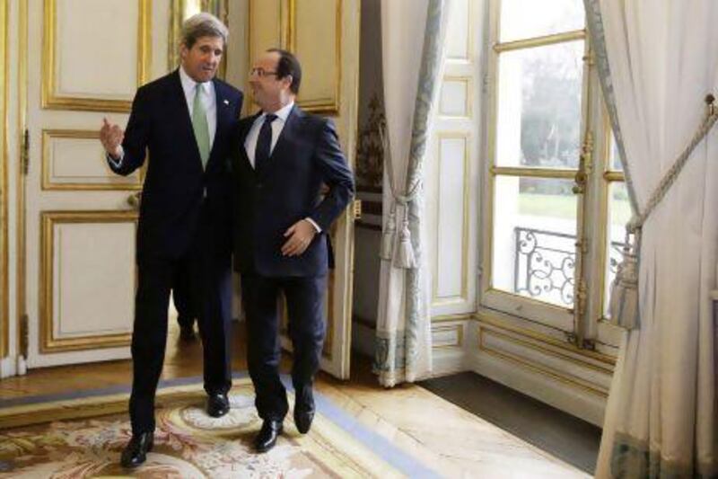 John Kerry, the US secretary of state, walks with French President Francois Hollande after their meeting in Paris on Wednesday. Jacquelyn Martin / Reuters