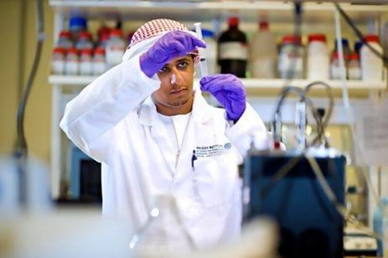 Masdar Institute student Ahmed Al Harithi at work on his research project exploring the potential for local strains of algae to produce biofuel for the UAE. Mike Malate / Masdar Institute