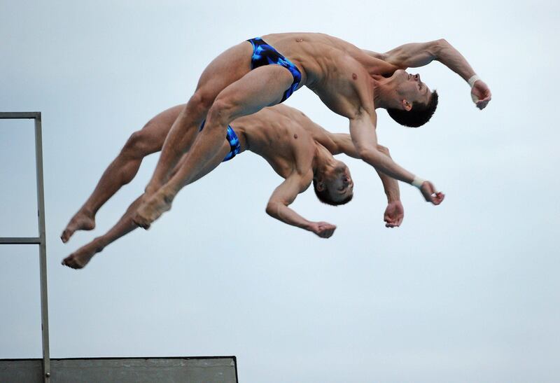 Germany's Patrick Hausding and Sascha Klein compete in the final of the men's 10-metre synchronised platform diving event of the FINA World Championships at the outdoor diving pool at the Oriental Sports Centre in Shanghai on July 17, 2011. Germany's Patrick Hausding and Sascha Klein placed second for silver.  AFP PHOTO / PETER PARKS
 *** Local Caption ***  437249-01-08.jpg