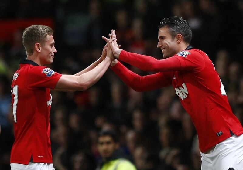 Manchester United player James Wilson, left, is congratulated by teammate Robin Van Persie as he is substituted during their Premier League match on Tuesday against Hull City at Old Trafford. Darren Staples / Reuters / May 6, 2014