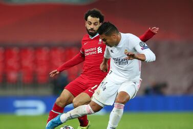 Liverpool's Mohamed Salah (left) and Real Madrid's Carlos Casemiro battle for the ball during the UEFA Champions League match at Anfield, Liverpool. Picture date: Wednesday April 14, 2021. See PA story SOCCER Liverpool. Photo credit should read: Peter Byrne/PA Wire. RESTRICTIONS: Editorial use only, no commercial use without prior consent from rights holder.