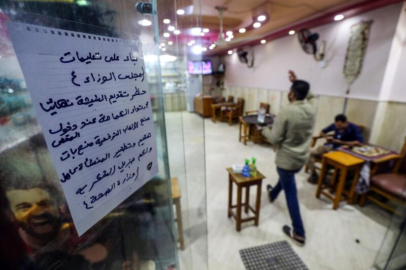 A note asking people to follow the instructions of the Health Ministry is pictured on the door of a cafe in the Egyptian capital Cairo. AFP