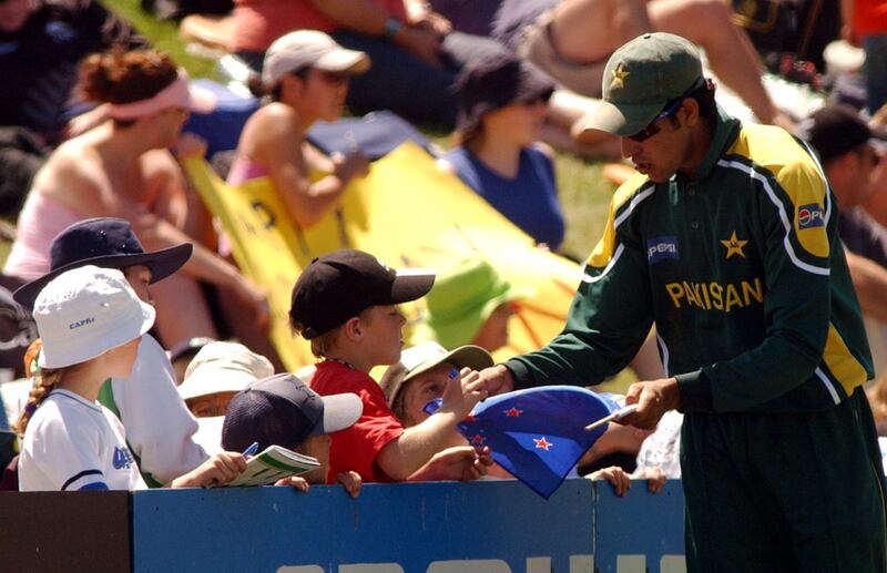 NEW ZEALAND - JANUARY 07:  Pakistan's Umar Gul signs autographs during the match against New Zealand in the second one day international cricket match at the Queenstown Events Centre, Queenstown, Wednesday, Jan 07, 2004.  (Photo by Ross Setford/Getty Images)