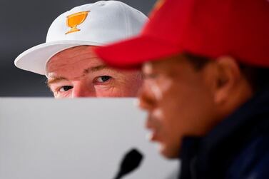 International Team captain Ernie Els of South Africa (L) anlistens to captain of the US team Tiger Woods (R) espeak during a press conference ahead of the Presidents Cup golf tournament in Melbourne on December 10, 2019. The Presidents Cup is to played at the Royal Melbourne Colf Club on December 12-15. / AFP / William WEST