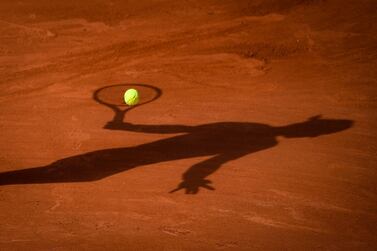 The shadow of Spain's Rafael Nadal is pictured as heA returns the ball to Britain's Cameron Norrie during their men's singles third round tennis match on Day 7 of The Roland Garros 2021 French Open tennis tournament in Paris on June 5, 2021. / AFP / Christophe ARCHAMBAULT