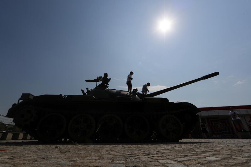 A Red Star Belgrade fan stands on the Soviet-made T-55 main battle tank in front of Rajko Mitic stadium. Reuters