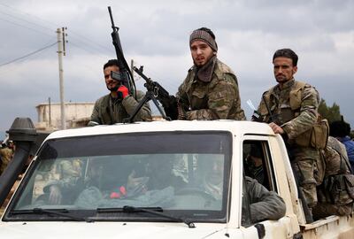 Turkish-backed Syrian opposition fighters move in a vehicle as they battle for control of the village of al-Bayyah northeast of the town of Afrin near the border with Turkey on February 21, 2018.  / AFP PHOTO / Nazeer al-Khatib