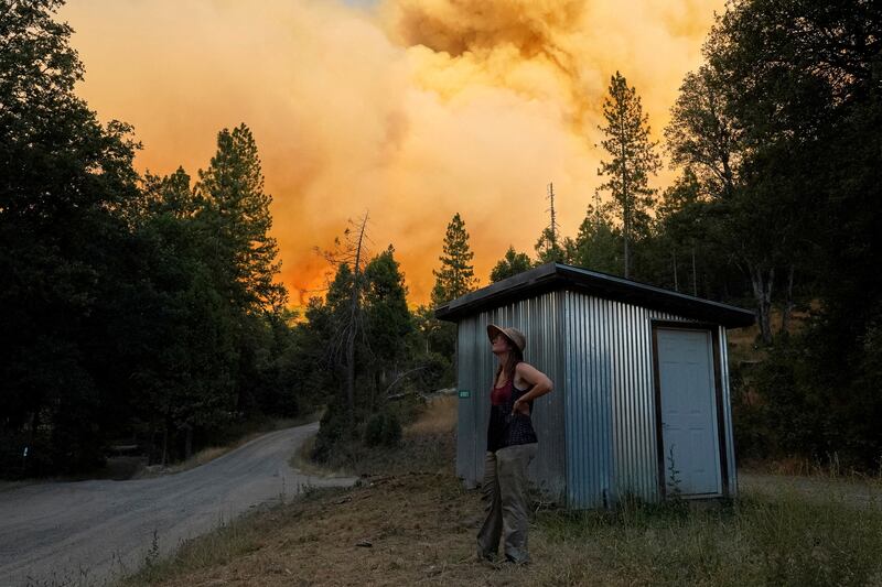 Allison Baggett watches as the Oak fire burns close to her home in Mariposa county, shortly before evacuating. Reuters