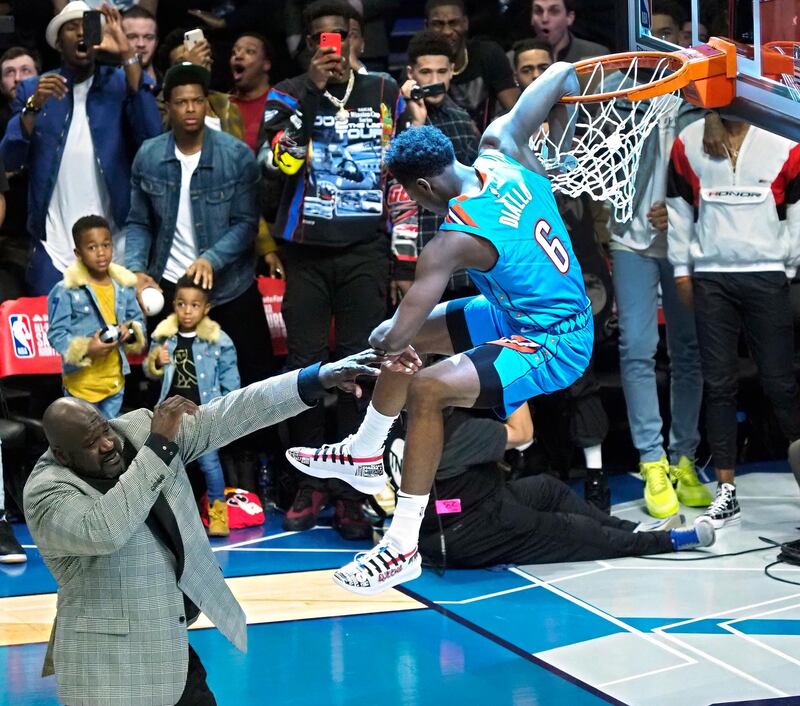 Oklahoma City player Hamidou Diallo (R) dunks the ball over the top of Shaquille O'Neal (L) in the Slam Dunk Contest during the All-Star Saturday Night on All-Star Weekend at the Spectrum Center in Charlotte, North Carolina, USA, 16 February 2019.  EPA