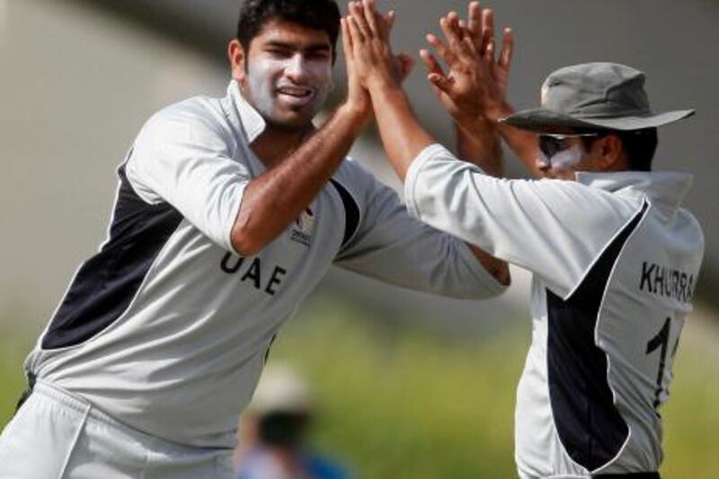 Dubai, April 9, 2011 - The UAE's bowler Ahmed Raza (L) and Khurram Khan (R) celebrate after they take a wicket against Paupa New Guinea in their World Cricket League Division 2 50-over in Dubai Sports City, Dubai, April 9, 2011. (Jeff Topping/The National)