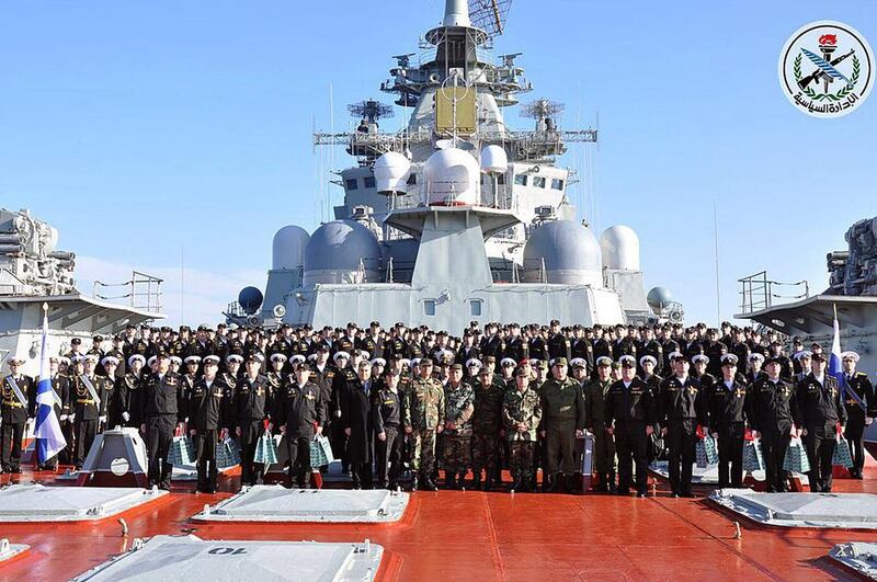 Syrian army chief Gen Ali Abdullah Ayoub poses with the crew of Russian aircraft carrier Admiral Kuznetsov at the end of its mission off the Syrian coast in Tartus on January 6, 2017. Sana / EPA
