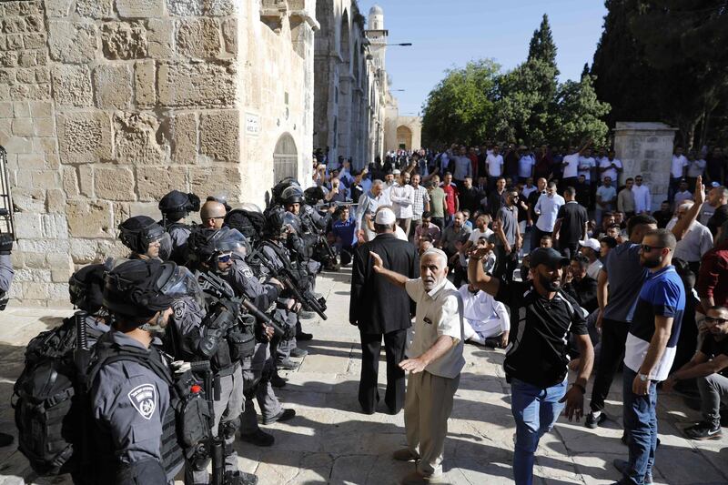 Palestinian Muslims face Israeli security forces as tensions rise inside the Al Aqsa Mosque compound. AFP