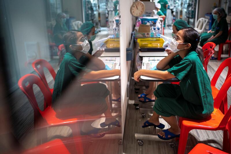 Nurses wearing face masks monitor COVID-19 patients in the ICU at the Emerging Infectious Disease Clinic in King Chulalongkorn Memorial Hospital in Bangkok, Thailand. Athit Perawongmetha