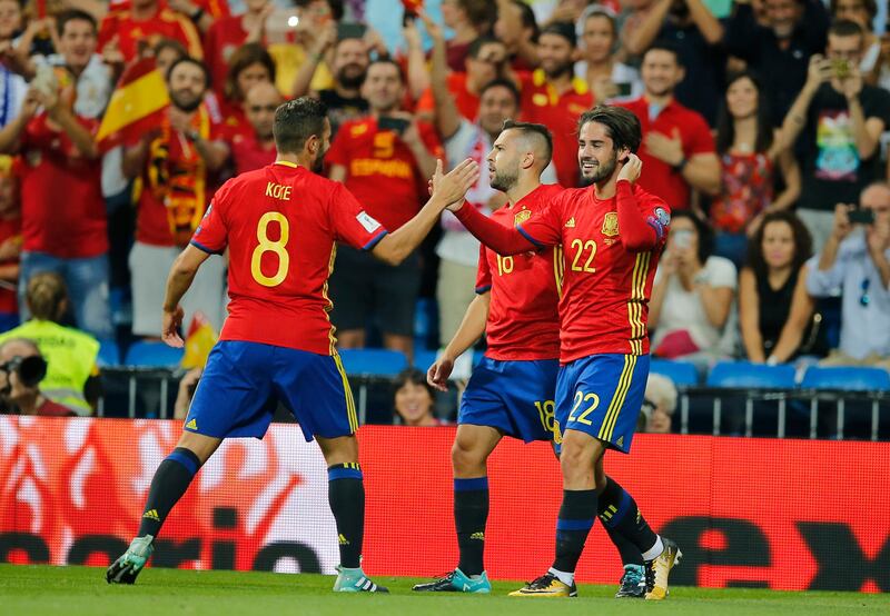 Spain's Isco, right, celebrates after scoring the opening goal during the World Cup Group G qualifying soccer match between Spain and Italy at the Santiago Bernabeu Stadium in Madrid, Saturday Sept. 2, 2017. (AP Photo/Paul White)