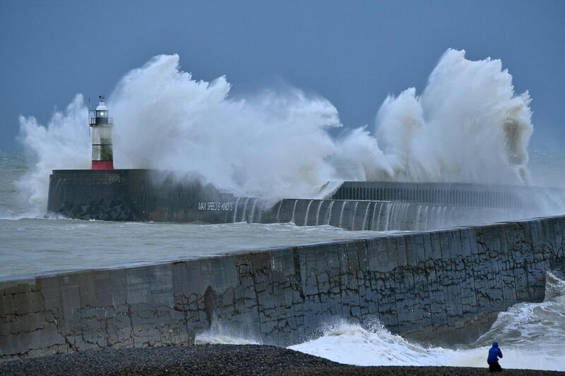 (FILES) In this file photo taken on December 27, 2020 Waves crash over Newhaven Lighthouse and the harbour wall on the south coast of England on December 27, 2020, as Storm Bella brings rain and high winds to the UK. Britain generated more than 50% of its energy from wind power for the first time on December 26 in the wake of Storm Bella, according to energy company Drax. Storm Bella swept through part of the United Kingdom on December 27 and then through northern and central France with wind gusts of up to 143 km/h in coastal areas. Offshore wind power is at the heart of the "green" strategy of Boris Johnson's Conservative government.

 / AFP / Glyn KIRK                          
