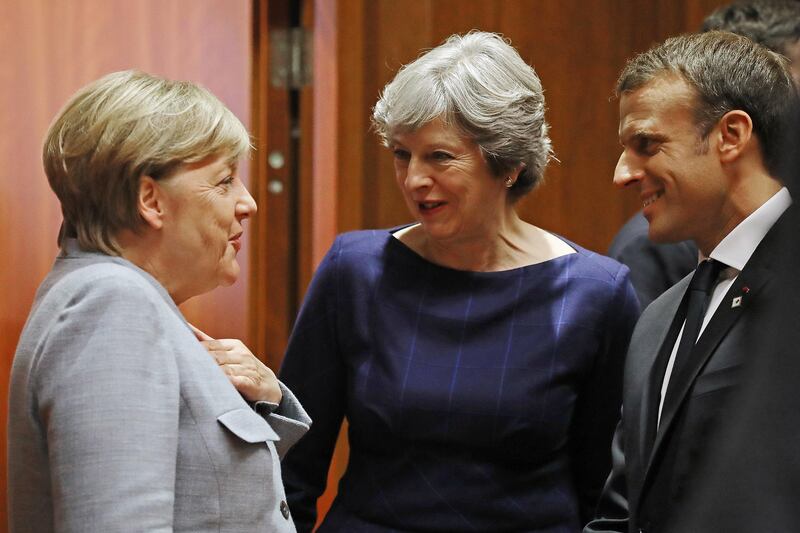 BRUSSELS, BELGIUM - OCTOBER 19:  German Chancellor Angela Merkel, Britain's Prime Minister Theresa May and French President Emmanuel Macron arrive for a round table meeting on October 19, 2017 in Brussels, Belgium. Under discussion are the Iran Nuclear Deal, Brexit and North Korea. Mrs May has offered assurances to EU nationals that her government will make it as easy as possible to remain living in the United Kingdom after Brexit.  (Photo by Dan Kitwood/Getty Images)