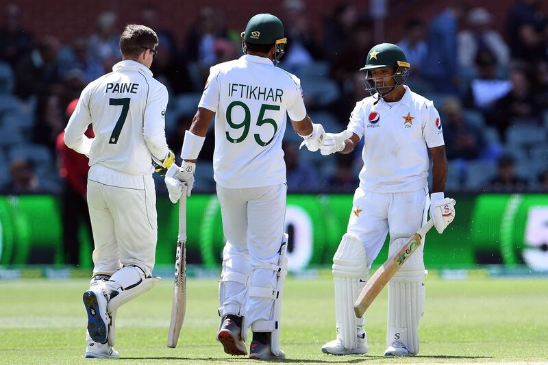 Pakistan's Asad Shafiq, right, celebrates after reaching his fifty on day four of the second Test in Adelaide on Monday. AFP
