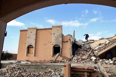 A youth climbs the rubble of a destroyed building in Tawergha, near the port city Misrata, on December 12, 2020. AFP