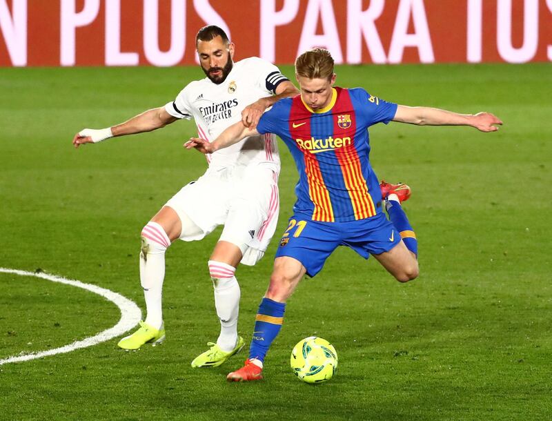 Real Madrid's Karim Benzema in action with Barcelona's Frenkie de Jong. Reuters