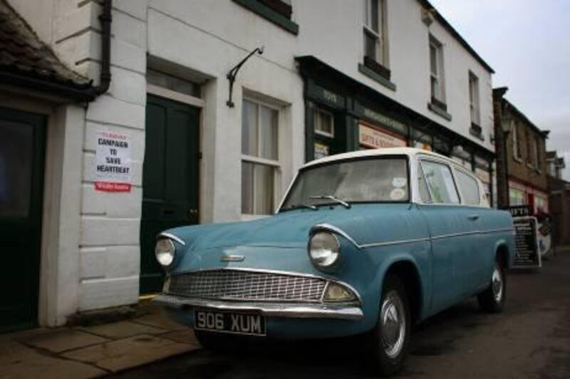 GOATHLAND, UNITED KINGDOM - FEBRUARY 20: A classic Ford Anglia police car sits in 'Aidensfield' on February 20, 2009 in Goathland, United Kingdom. Picturesque Goathland sits in the valleys of the North Yorkshire Moors and is the location for the popular Heartbeat televison drama which may be axed by ITV. Residents have raised a petition to save the series as villagers fear that the end of the show will bring widespread job losses due to the decline in tourism and money being put into the rural economy. Thousands of fans of the drama flock to see where it is filmed every year.  (Photo by Christopher Furlong/Getty Images)